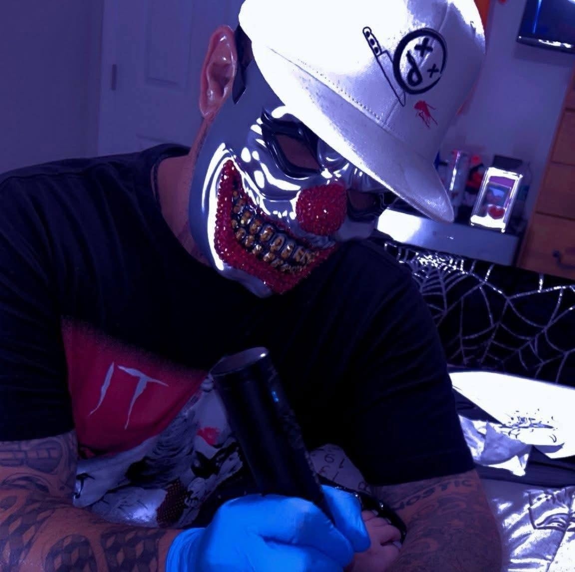 A tattoo artist is inking a design.